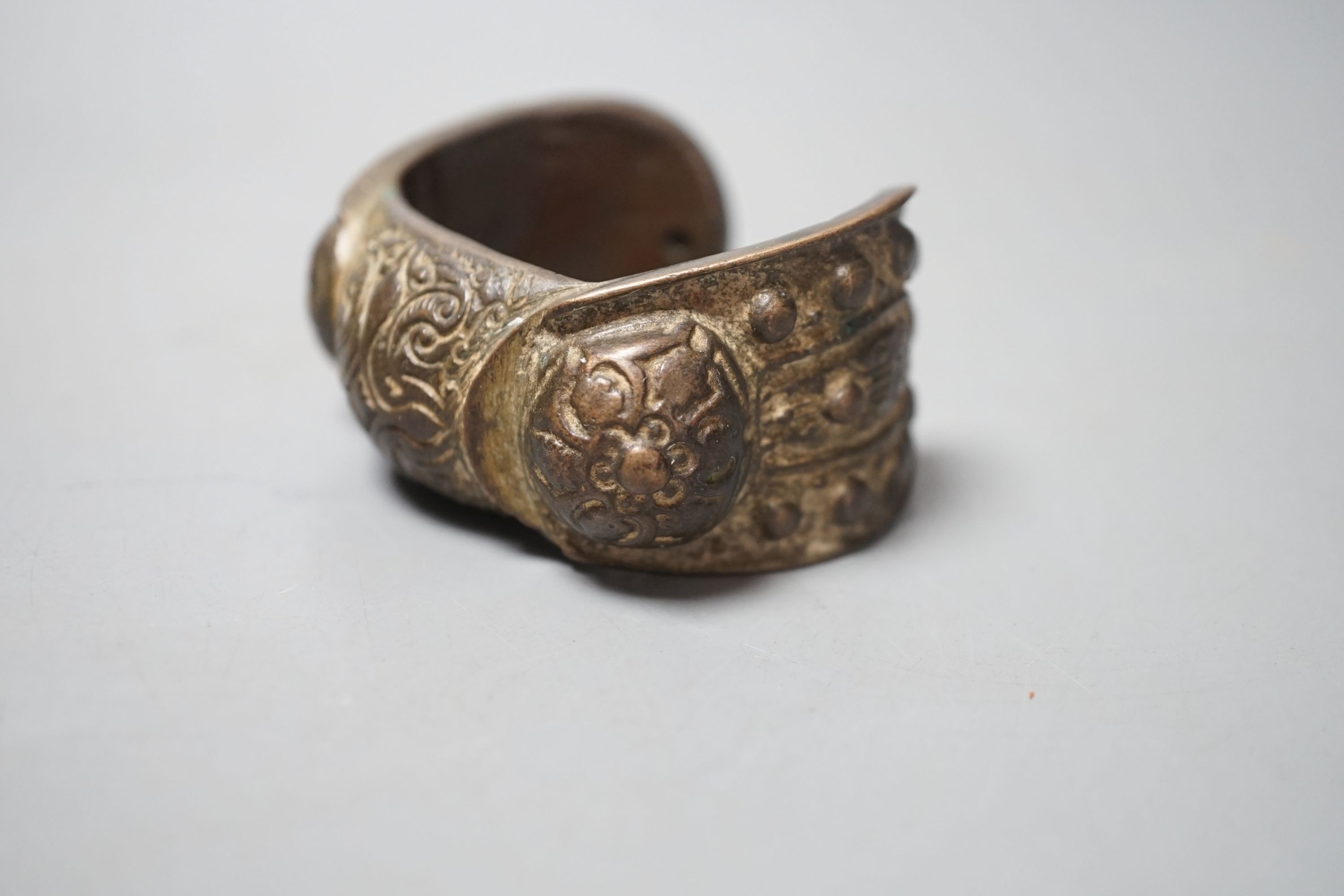 A Chinese brass bangle